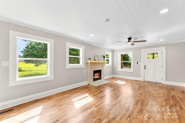 410 Gann St, Lowell, NC 28098 - unfurnished living room featuring ornamental molding, light wood-style floors, recessed lighting, a fireplace with flush hearth, and a ceiling fan