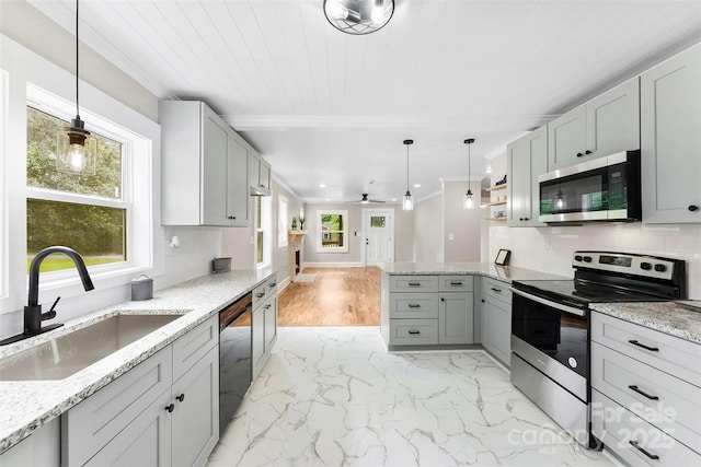 410 Gann St, Lowell, NC 28098 - kitchen featuring appliances with stainless steel finishes, a peninsula, crown molding, gray cabinets, and light stone countertops