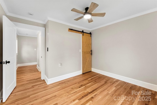 410 Gann St, Lowell, NC 28098 - unfurnished bedroom with light wood-type flooring, a barn door, crown molding, and ceiling fan