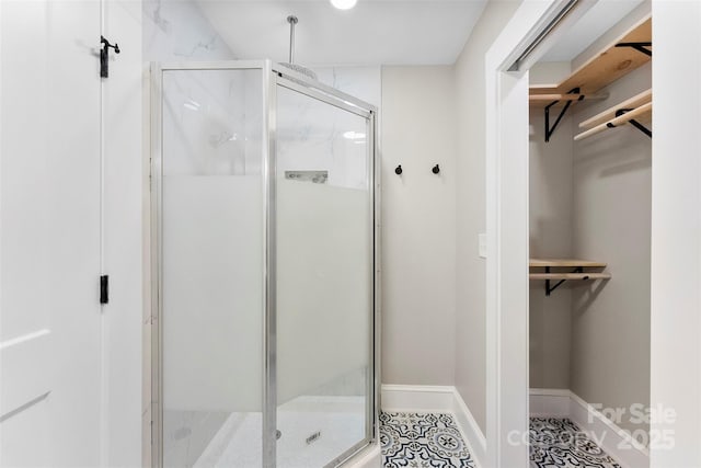 410 Gann St, Lowell, NC 28098 - full bath with a shower stall, a spacious closet, and tile patterned flooring