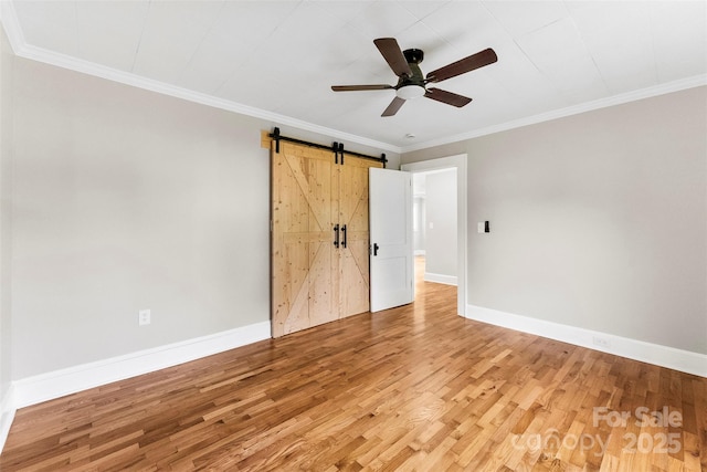 410 Gann St, Lowell, NC 28098 - unfurnished bedroom with light wood-type flooring, a barn door, ornamental molding, and a ceiling fan