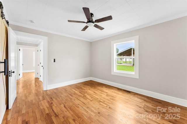 410 Gann St, Lowell, NC 28098 - spare room with attic access, light wood-type flooring, crown molding, a ceiling fan, and a smoke detector