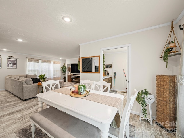 601 Lhasa Apso Ln, Iron Station, NC 28080 - dining space featuring light wood-style floors, crown molding, a textured ceiling, and recessed lighting