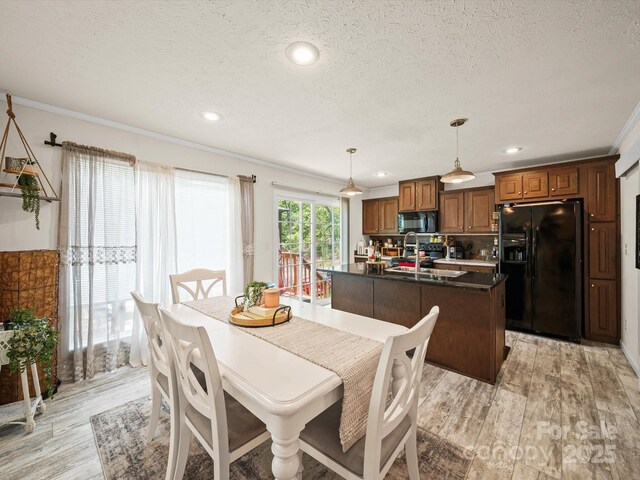 601 Lhasa Apso Ln, Iron Station, NC 28080 - dining area with light wood finished floors, crown molding, a textured ceiling, and recessed lighting