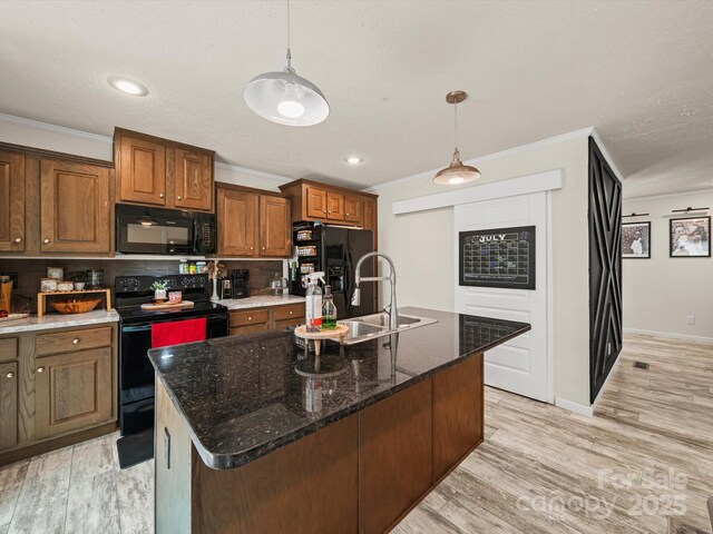 601 Lhasa Apso Ln, Iron Station, NC 28080 - kitchen with black appliances, crown molding, decorative backsplash, brown cabinetry, and a center island with sink
