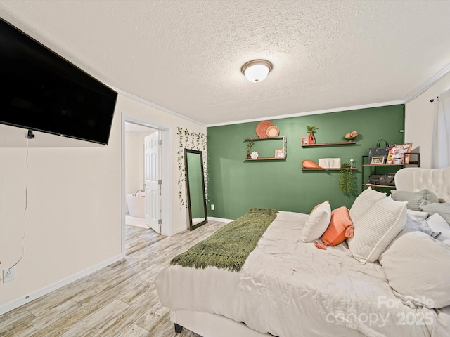 601 Lhasa Apso Ln, Iron Station, NC 28080 - bedroom with ornamental molding, a textured ceiling, wood finished floors, and ensuite bathroom