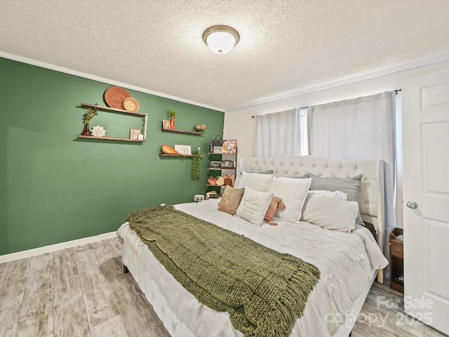 601 Lhasa Apso Ln, Iron Station, NC 28080 - bedroom with a textured ceiling, wood finished floors, and ornamental molding