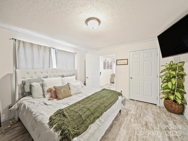 601 Lhasa Apso Ln, Iron Station, NC 28080 - bedroom with crown molding, a textured ceiling, and wood finished floors