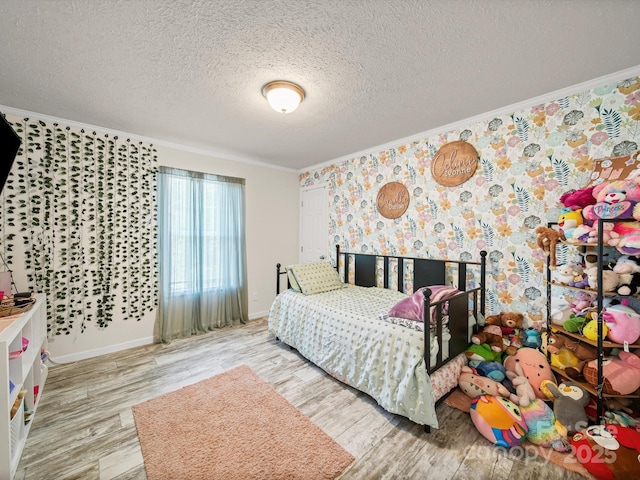 601 Lhasa Apso Ln, Iron Station, NC 28080 - bedroom with crown molding, wood finished floors, a textured ceiling, and wallpapered walls