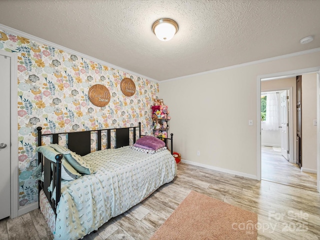 601 Lhasa Apso Ln, Iron Station, NC 28080 - bedroom featuring ornamental molding, wood finished floors, a textured ceiling, and wallpapered walls