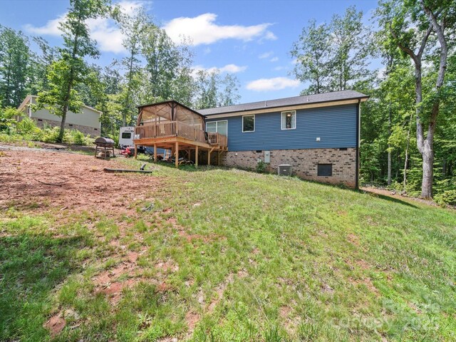 601 Lhasa Apso Ln, Iron Station, NC 28080 - back of house featuring a wooden deck, a yard, and brick siding