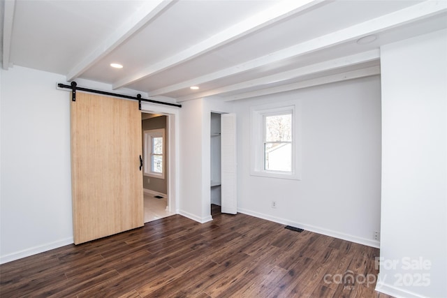 678 Wagner St, Troutman, NC 28166 - unfurnished bedroom featuring beamed ceiling, a barn door, dark wood-type flooring, multiple windows, and a closet