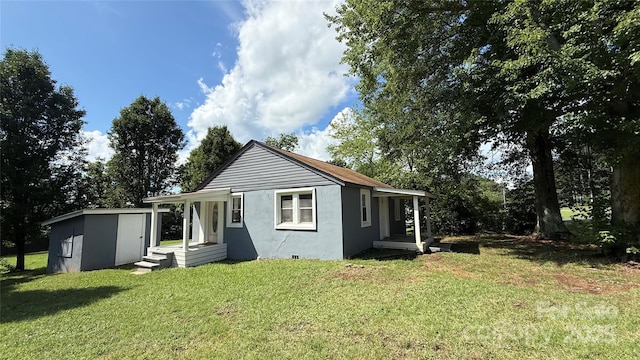 678 Wagner St, Troutman, NC 28166 - rear view of property with a lawn and stucco siding