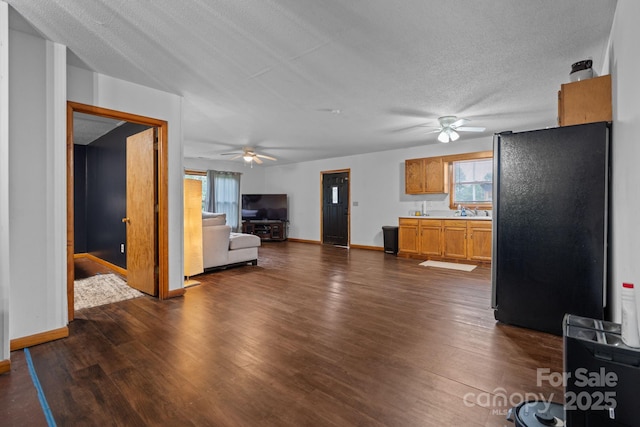 306 Forest Ave, Franklin, NC 28734 - unfurnished living room featuring ceiling fan, dark wood-style flooring, and a textured ceiling