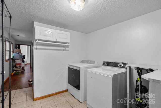 306 Forest Ave, Franklin, NC 28734 - laundry room with washer and clothes dryer, light tile patterned floors, and a textured ceiling