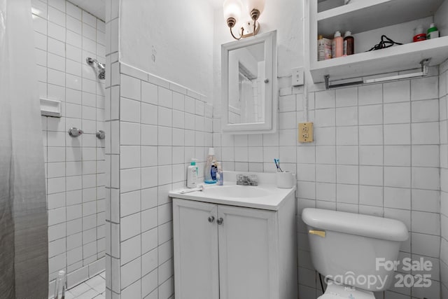 306 Forest Ave, Franklin, NC 28734 - full bathroom with tile walls, a shower stall, vanity, and wainscoting