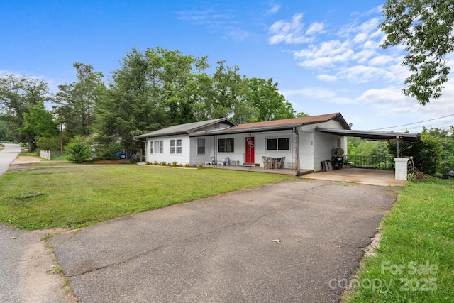 306 Forest Ave, Franklin, NC 28734 - ranch-style house featuring asphalt driveway, a front lawn, and a carport