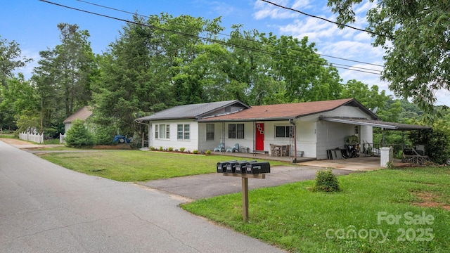 306 Forest Ave, Franklin, NC 28734 - ranch-style house with driveway, a front yard, a porch, and a carport