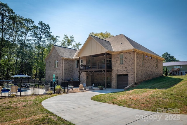 2545 10th Street Ct NE, Hickory, NC 28601 - rear view of house featuring concrete driveway, brick siding, an attached garage, and board and batten siding