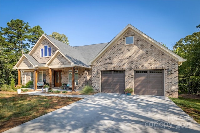 2545 10th Street Ct NE, Hickory, NC 28601 - view of front of property featuring covered porch, brick siding, concrete driveway, an attached garage, and a front lawn