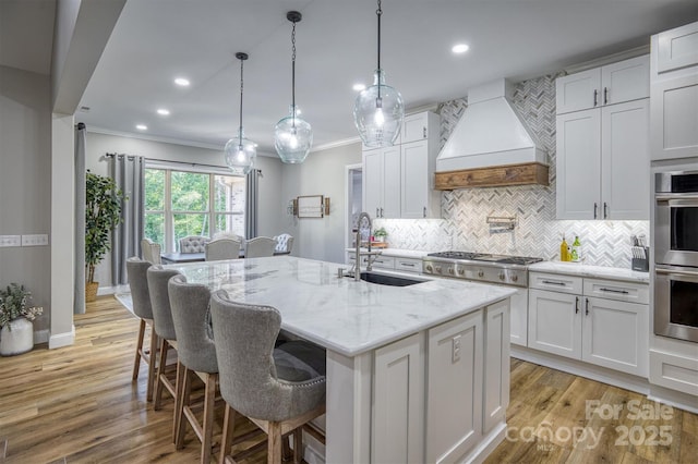 2545 10th Street Ct NE, Hickory, NC 28601 - kitchen with custom range hood, stainless steel appliances, crown molding, a center island with sink, and backsplash