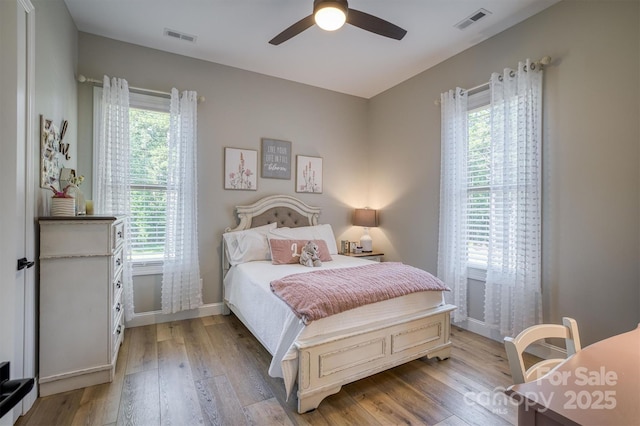 2545 10th Street Ct NE, Hickory, NC 28601 - bedroom featuring multiple windows, light wood-style flooring, and a ceiling fan