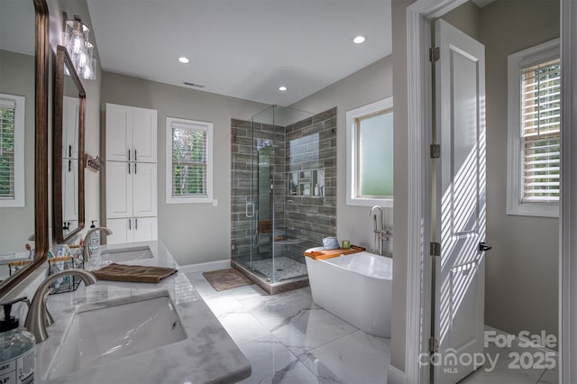2545 10th Street Ct NE, Hickory, NC 28601 - full bathroom featuring double vanity, a freestanding bath, a shower stall, healthy amount of natural light, and recessed lighting