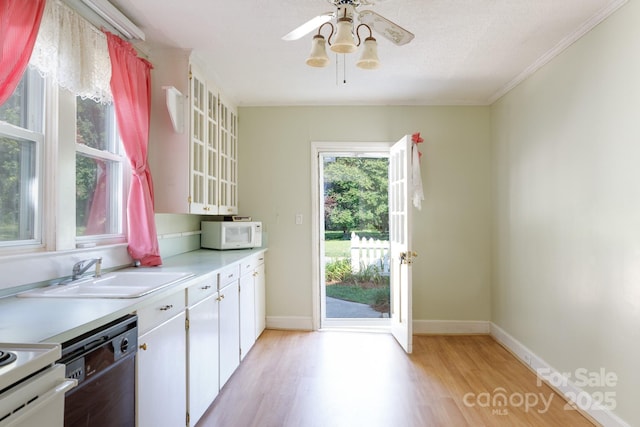 221 Kings Mountain St, Clover, SC 29710 - kitchen with white microwave, light wood-style floors, dishwasher, light countertops, and ornamental molding