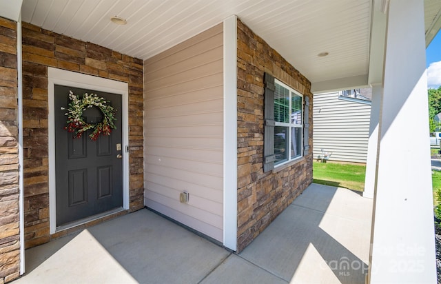 10666 Sapphire Trl, Davidson, NC 28036 - view of exterior entry with a porch and stone siding