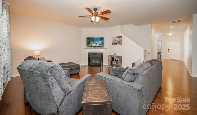 10666 Sapphire Trl, Davidson, NC 28036 - living area with wood finished floors, ceiling fan, stairway, a fireplace with flush hearth, and recessed lighting