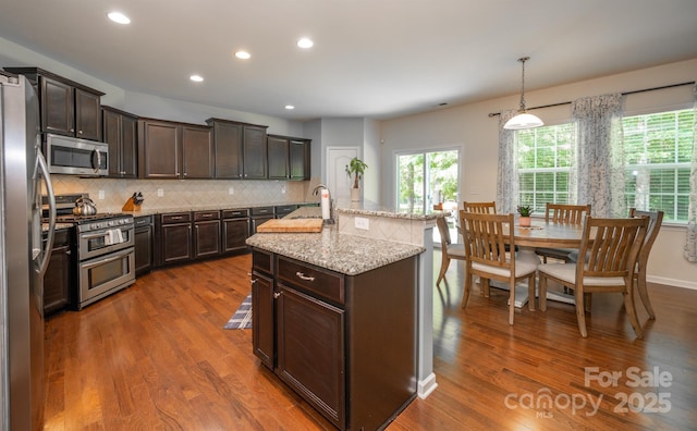 10666 Sapphire Trl, Davidson, NC 28036 - kitchen with appliances with stainless steel finishes, dark wood-style flooring, healthy amount of natural light, dark brown cabinets, and recessed lighting