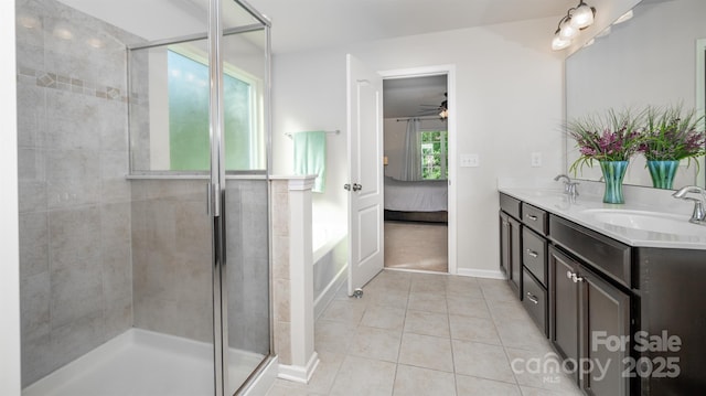 10666 Sapphire Trl, Davidson, NC 28036 - ensuite bathroom featuring tile patterned floors, double vanity, a ceiling fan, a shower stall, and a bath