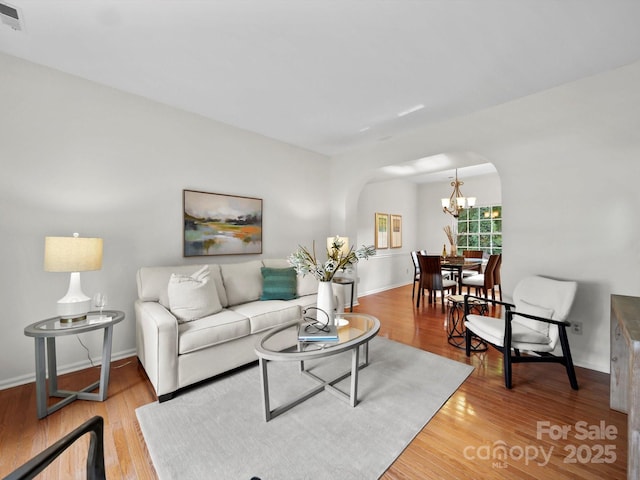 2808 Williams Station Rd, Matthews, NC 28105 - living area with arched walkways, a chandelier, and light wood finished floors