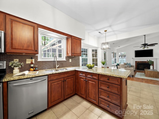 2808 Williams Station Rd, Matthews, NC 28105 - kitchen featuring appliances with stainless steel finishes, light tile patterned floors, a peninsula, backsplash, and light stone counters