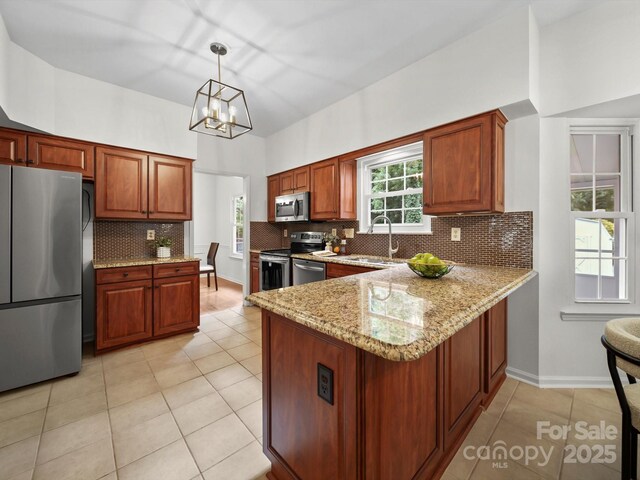 2808 Williams Station Rd, Matthews, NC 28105 - kitchen with stainless steel appliances, light stone countertops, a chandelier, light tile patterned flooring, and backsplash