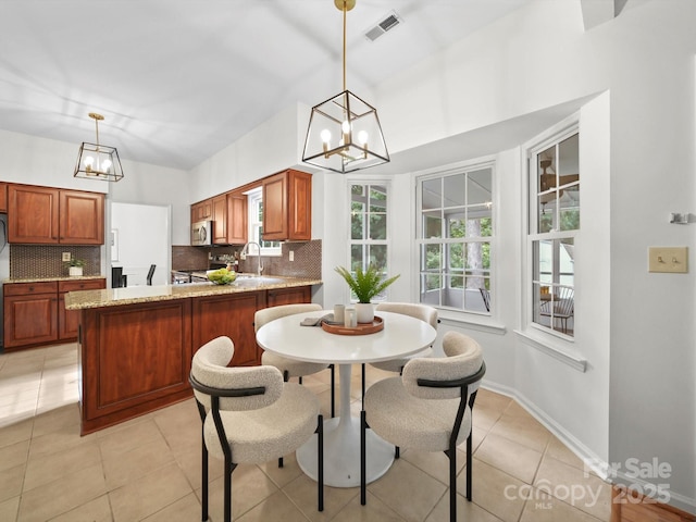 2808 Williams Station Rd, Matthews, NC 28105 - dining room featuring a chandelier and light tile patterned flooring