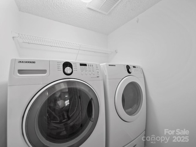 2808 Williams Station Rd, Matthews, NC 28105 - laundry area featuring washer and dryer and a textured ceiling