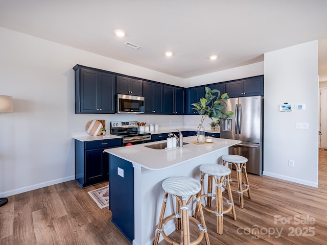 2511 Ruby Dixon Crossing Dr Unit 23, Gastonia, NC 28056 - kitchen with appliances with stainless steel finishes, a breakfast bar area, light wood-style floors, light countertops, and recessed lighting