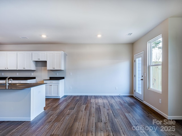 2511 Ruby Dixon Crossing Dr Unit 23, Gastonia, NC 28056 - kitchen featuring dark countertops, dark wood finished floors, white cabinetry, and recessed lighting