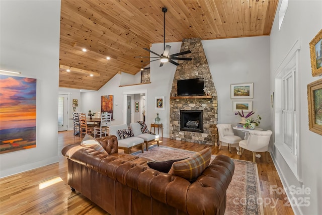 5283 Mount Olive Church Rd, Morganton, NC 28655 - living area with a ceiling fan, wooden ceiling, a stone fireplace, light wood-style flooring, and high vaulted ceiling