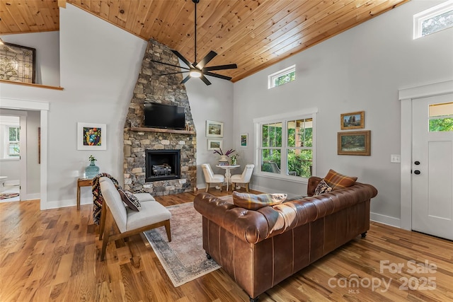 5283 Mount Olive Church Rd, Morganton, NC 28655 - living room featuring high vaulted ceiling, wood ceiling, ceiling fan, wood finished floors, and a stone fireplace