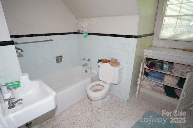 1400 Central Dr, Kannapolis, NC 28083 - bathroom with tile walls, a bath, speckle patterned floor, and a wainscoted wall