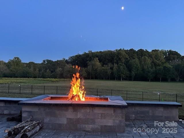 1140 Shinnville Rd, Cleveland, NC 27013 - view of patio / terrace featuring an outdoor fire pit and a forest view