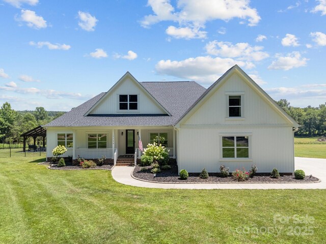 1140 Shinnville Rd, Cleveland, NC 27013 - modern inspired farmhouse featuring covered porch, a front lawn, and roof with shingles
