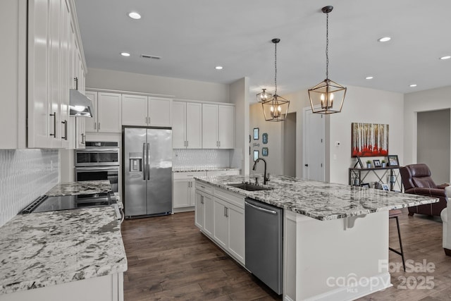 1140 Shinnville Rd, Cleveland, NC 27013 - kitchen featuring stainless steel appliances, backsplash, white cabinetry, open floor plan, and recessed lighting