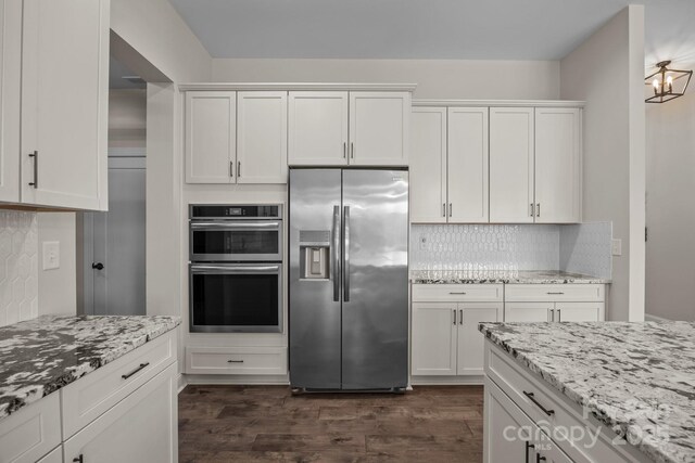 1140 Shinnville Rd, Cleveland, NC 27013 - kitchen with appliances with stainless steel finishes, white cabinets, dark wood-type flooring, and decorative backsplash