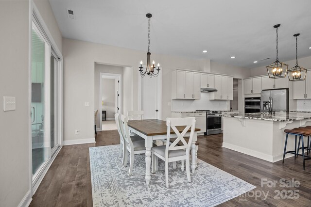 1140 Shinnville Rd, Cleveland, NC 27013 - dining space with a chandelier, dark wood-style flooring, and recessed lighting