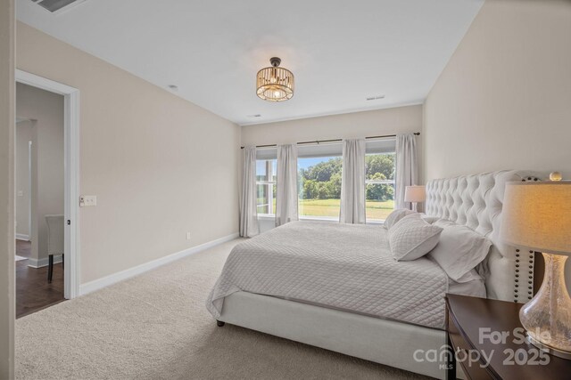 1140 Shinnville Rd, Cleveland, NC 27013 - bedroom with carpet floors and a chandelier