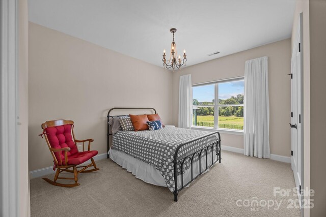 1140 Shinnville Rd, Cleveland, NC 27013 - carpeted bedroom with baseboards and a chandelier