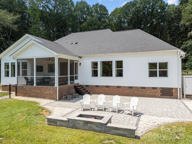 1140 Shinnville Rd, Cleveland, NC 27013 - rear view of property featuring crawl space, a sunroom, an outdoor fire pit, a shingled roof, and a patio